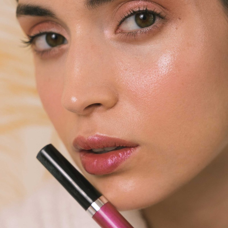 Woman lips close-up wearing lip gloss intense rose color