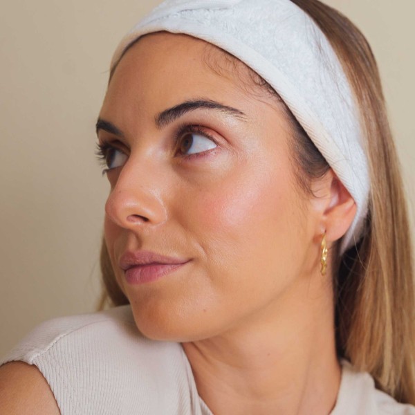 mujer con maquillaje natural, sombras veganas en tonos tierra, colorete rosado e iluminador dorado